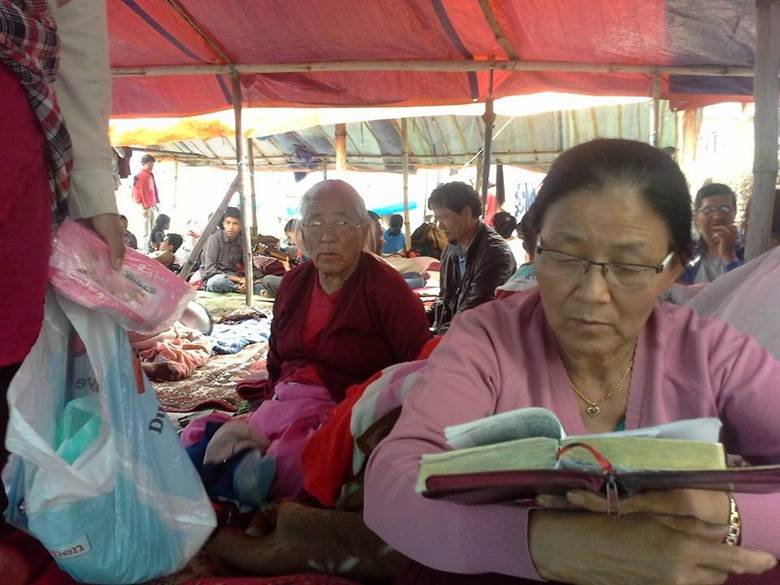 woman in a tent reading the Bible