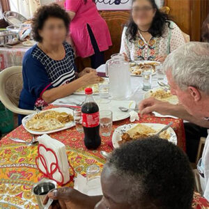 people gathered around a table sharing a meal