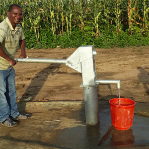 man pumping water from a well